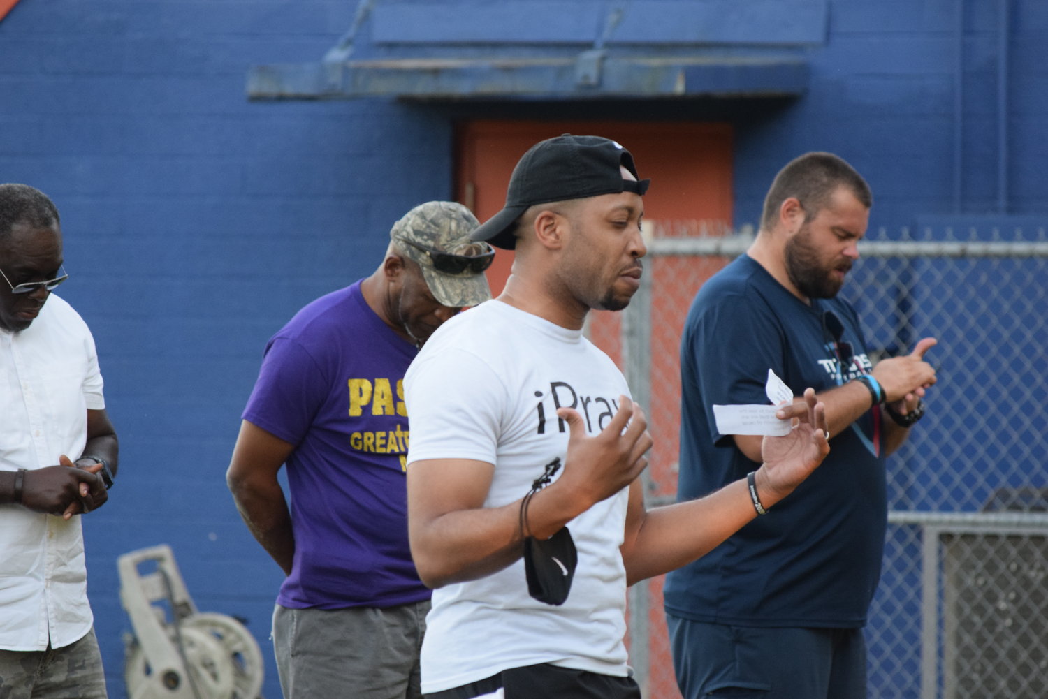 A Brookshire area resident gives a prayer at the praytest event. People of several racial and cultural backgrounds joined in the event.